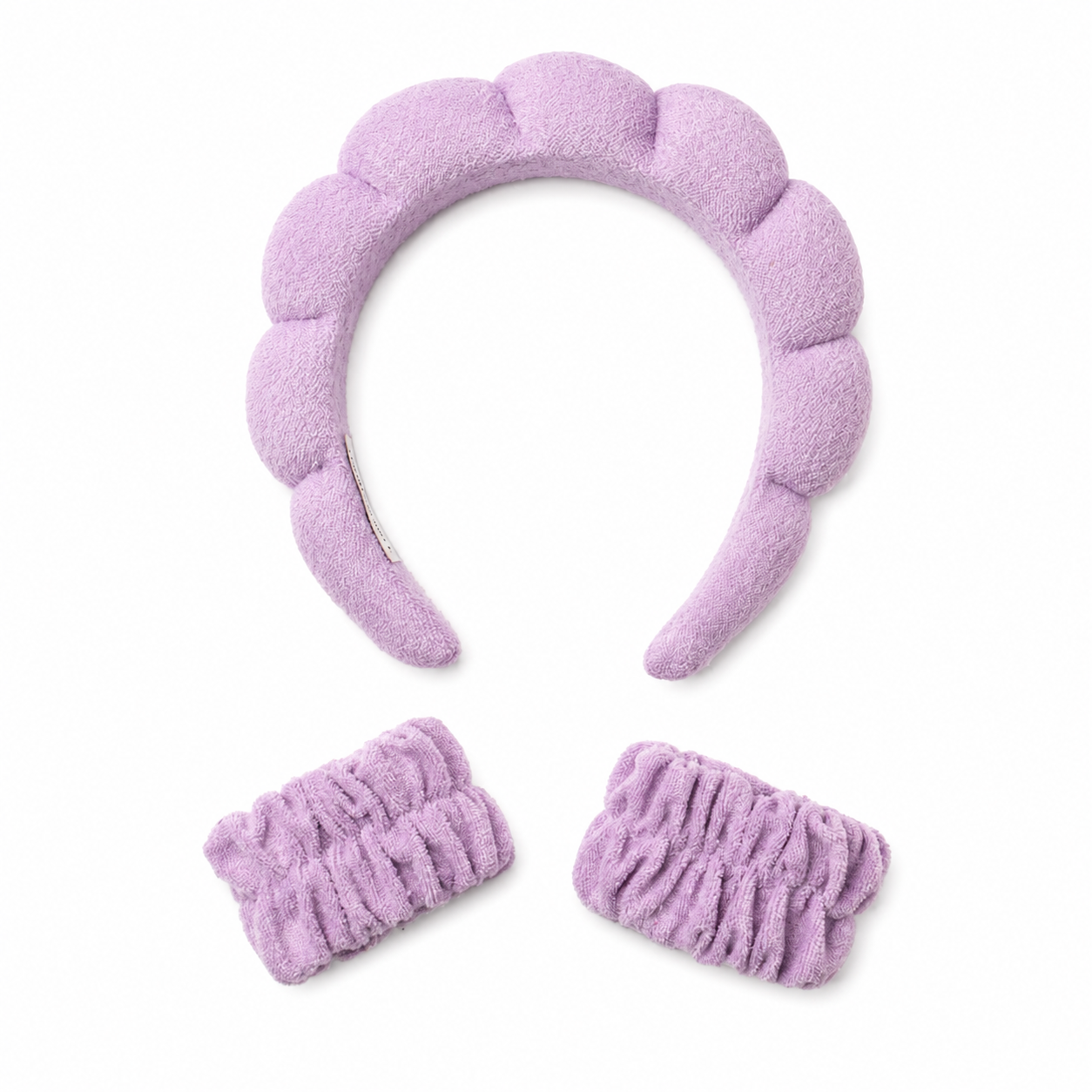 Soft purple hairband and matching elastic wristbands on a white background